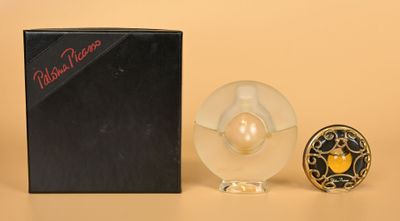 a small glass object next to a box on a table
