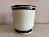 a black and white cup sitting on a marble table