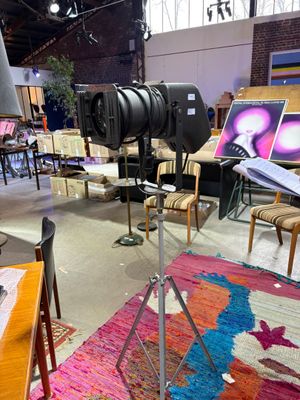 a camera on a tripod in the middle of a room
