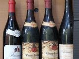 several bottles of wine are lined up on a shelf in a box
