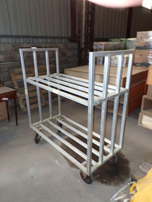 a picture of a cart in a warehouse with a lot of boxes