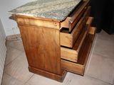 a wooden cabinet with a granite top in a kitchen