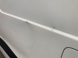 a white car with a hole in the side of it