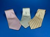 three different colored neck ties on a blue background