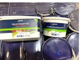 two buckets of paint sitting next to each other on a table