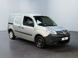 the small silver van is parked in a large room