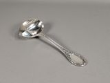 a silver spoon with a spoon handle on a table