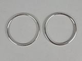 two silver rings on a white surface with a white background