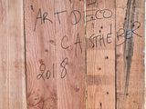 a wooden door with graffiti written on it