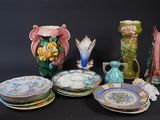 many plates and vases that are sitting on a table