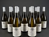 six bottles of wine are lined up in a row on a table