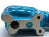 a blue dog bone shaped object on a white surface