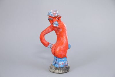 figurine of a man with a hat and glasses on his head