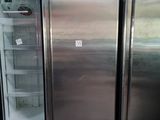 three stainless steel refrigerators that are in a room