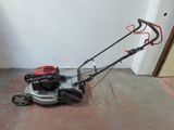 a small lawn mower that is sitting on the floor