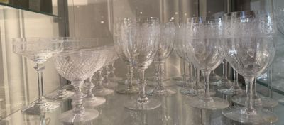 many wine glasses sitting on a glass shelf