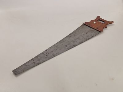 a close up of a wooden hand saw on a white surface