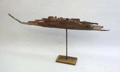 an image of a wooden sculpture of a ship on a stand
