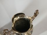 a silver plated cup and saucer on a white background