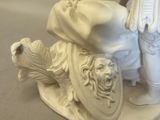 a statue of a man riding a motorcycle with a dog on the back