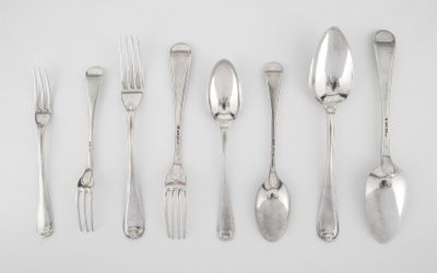 a lot of spoons and forks on the table