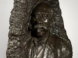 bronze bust of a man with a beard and a mustache