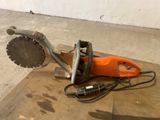 an orange and black circular saw on the floor