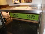 a green kiwifrit sign on the counter in the kitchen