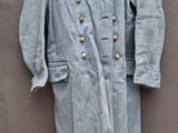 un manteau bleu suspendu à un cintre accroché au mur