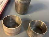 two silver cups sitting on top of a table next to a box