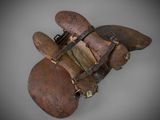an old wooden glove with a metal buckle on it