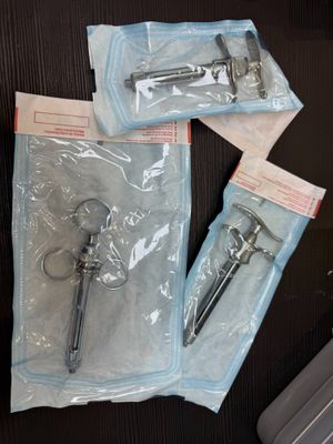 three pairs of scissors on a table next to a laptop
