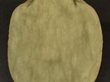 a close up of a green hat sitting on top of a black surface