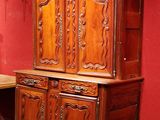 a large wooden cabinet in the middle of a room