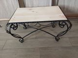 a small table with a wooden top on a wooden floor