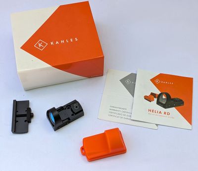 an orange box with a black handle and a white box with a black handle and a red handle and a black and white box with a black handle