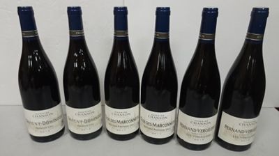 six bottles of wine are lined up on a table