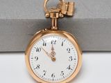 a gold pocket watch with a chain hanging from it ' s side