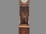 a grandfather clock that is on display on a gray background