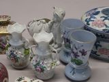 many different vases and bowls sitting on a table