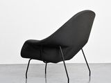 an image of a black chair sitting on top of a cement floor