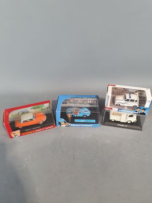 three boxed toy cars are sitting on a table next to each other
