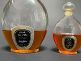 two bottles of liquor sitting next to each other on a table