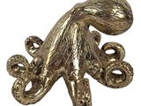 an image of a gold octopus statue on a white background