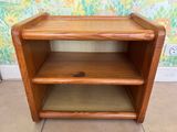 a small wooden shelf with two shelves on it