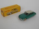 an old toy car and a box on a white surface