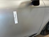 a sticker on the door of a silver car