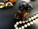 a necklace of pearls and a pair of earrings on a table