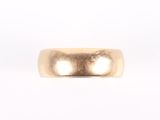 a close up of a gold ring on a white background