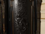 a black and gold cabinet in the corner of a room